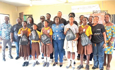 Abraham Nii Bortey Bortey (arrowed), Founder of Bridge Effect, with some of the beneficiaries and teachers after the donation