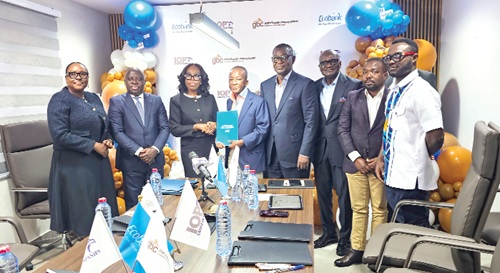Abena Osei-Poku (3rd from left), MD, Ecobank Ghana, and Isaac Ofori-Poku, Group Chairman, IOP Group and Executive Chairman, Ghana Bauxite Company, holding the signed documents. With them are other officials of Ecobank and Ghana Bauxite Company.  Picture: DOUGLAS ANANE-FRIMPONG