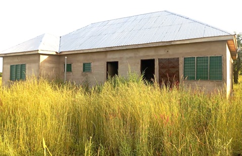 The uncompleted CHPS compound taken over by weeds
