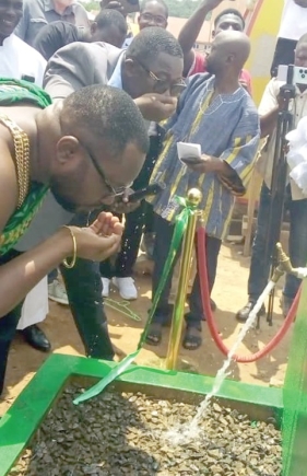 Godwin Bobobee (middle), District Chief Executive for Asuogyaman, and another dignitary sipping the water after the commissioning