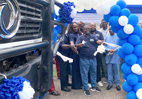 Joseph Boadu (middle), Deputy Director for Parts and Logistics, joined by Hilda Peasah (left), Marketing and Communications Director of SMT Ghana, and other dignitaries to cut the tape to launch the Dongfeng models