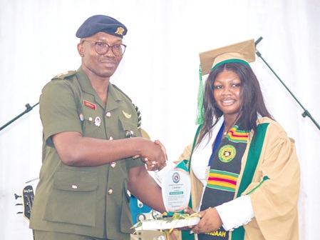 Nana Ama Pokuah Sarfo, the Valedictorian for the WASSCE Class of 2026 receiving her certificate from Lt. Col. George Appiah.