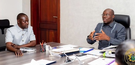 Dr Cassiel Ato Baah Forson (right), Minister of Finance, interacting with Rev. John Awuni, Chairman, FABAG