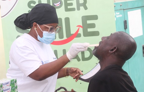 Priscilla Ameyaw (left) from Serepa Dental Clinic examining a beneficiary Priscilla Ameyaw (left) from Serepa Dental Clinic examining a beneficiary