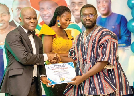 Ahmed Ibrahim (left), Minister of Works, Housing and Water Resources, presenting the Best Tourism award to Biiya Mukusah Ali, Bono Regional correspondent of Graphic