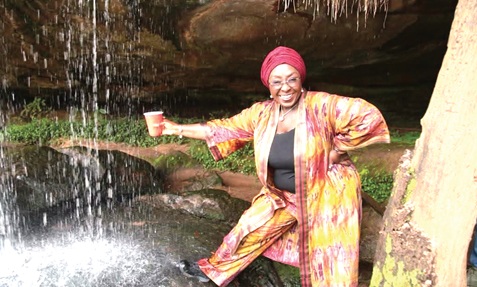 Abla Dzifa Gomashie, Tourism, Culture and Creative Arts Minister, enjoys the cascading waters at the third entry point of Kintampo Waterfalls during her familiarisation tour of tourist attractions in Bono East.