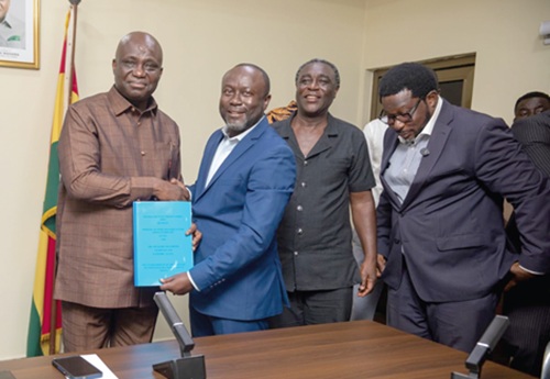 Eric Opoku (left), Minister of Food and Agriculture, and  Rev. Mark Nyantakyi, Managing Director, ABC Oyeasase Yie Ltd, shaking hands after the signing of the MoU