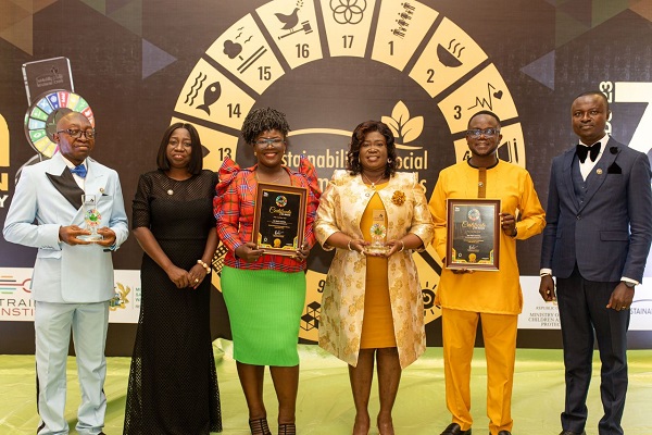 Dr Ameh (3rd from right) and some members of the management team displaying the various awards and citations received at the Sustainability and Social Investment Awards