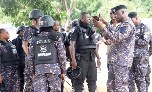 • Some police personnel deployed receiving breifing from one of their superiors 