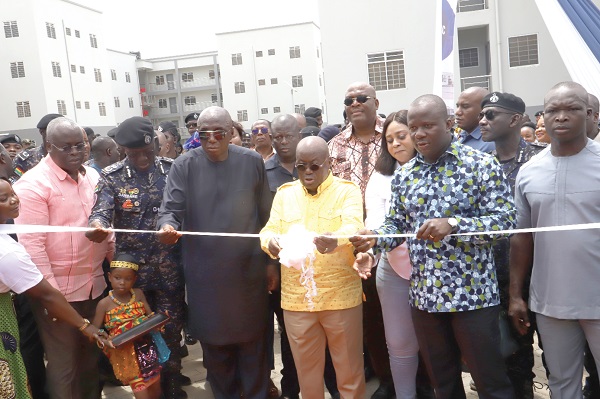 • President Akufo-Addo  (3rd from right) being assisted by Samuel Abu Jinapor (2nd from right), Minister of Lands and Natural Resources; Ambrose Dery (3rd from left), Minister for the Interior, and Dr George Akuffo Dampare,  (2nd from left), Inspector-General of Police, to cut a ribbon to inaugurate the barracks at Kwabenya