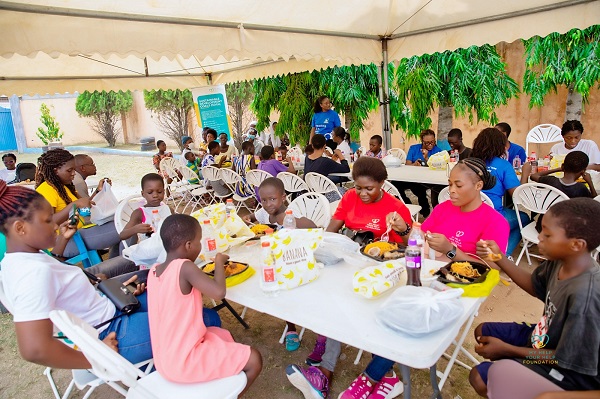 Myhelp-Yourhelp team sharing meals with the kids at Rev. Obli Centre