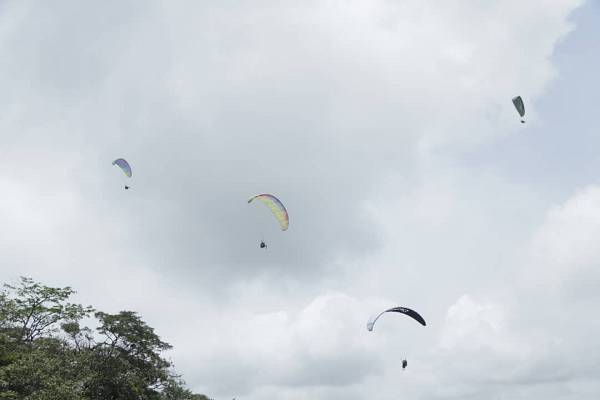 Pilots in flight at the Kwahu Paragliding range