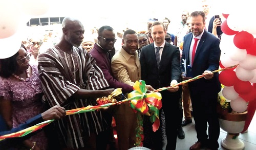 Shani Alhassan Shaibu (left), Northern Regional Minister, being assisted by Tristan Azbej (2nd from right), State Secretary at the Ministry of Foreign Affairs and Trade, Hungary, and some guests to commission the plant