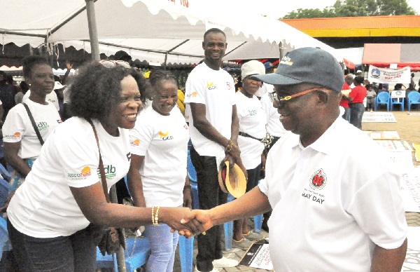 Dr Archibald Yao Letsa, Volta Regional Minister, in a hearty handshake with some members of the Judicial Service Staff Association of Ghana, at the May Day celebration