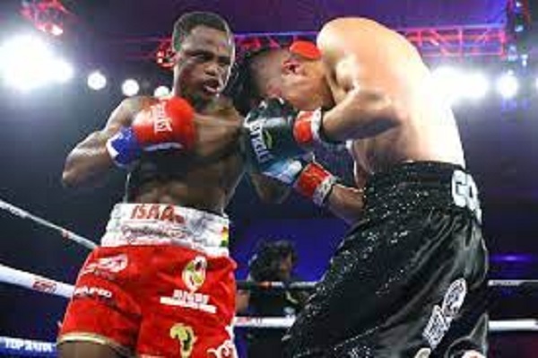 Dogboe (left) connects a left hook to the head of challenger, Gonzalez