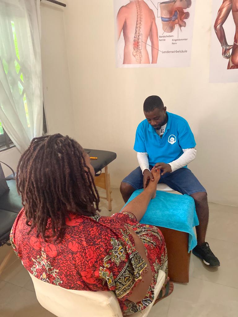 Mr Charles Ntisem, an Acupressure therapist of Kaiser Reha Physiotherapy and Massage  Centre working on a client