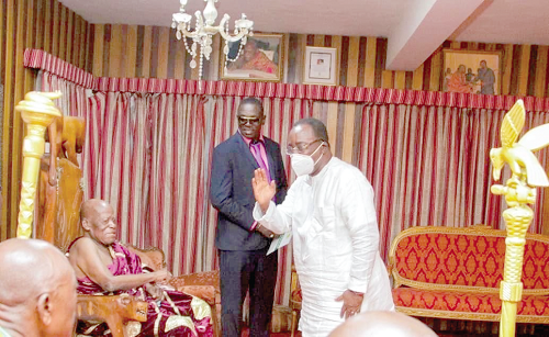 Dr Owusu Afriyie Akoto (right), Food and Agriculture Minister, exchanging greetings with Nana Akuoku Sarpong (seated), the Agogohene, at his palace in Agogo