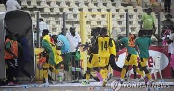 Black Stars players running to the dressing room after coming under attack during the pandemonium