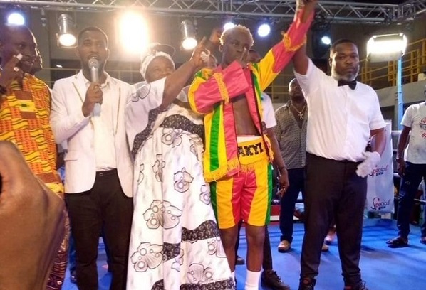 Referee Erasmus Owoo (right) declaring Samuel Takyi as the winner of the bout