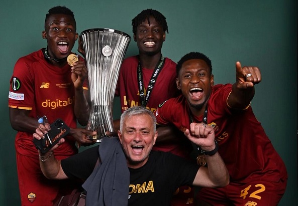 Felix  Afena - Gyan (left) celebrating with his manager, Jose Mourinho, and some teammates