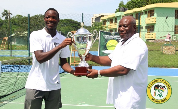 Samuel Antwi receiving the winner’s trophy from Neenyi Ghartey VII, Paramount Chief of the Efutu Traditional Area