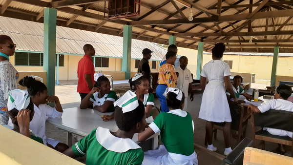Members of the club interacting with nurses at one of the wards
