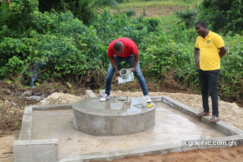 Ing. Sammy Adotei of CBN fixing a pump at the Owusukrom project site while Andrew Larbi Amoah, assemblyman for Amanfoso/Coaltar Electoral Area closely watches the process.