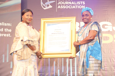 Madam Faustina Nelson (left) who was honoured for being a friend of the GJA receiving a citation from Ms Ajoa Yeboah-Afari, a board member of the GCGL