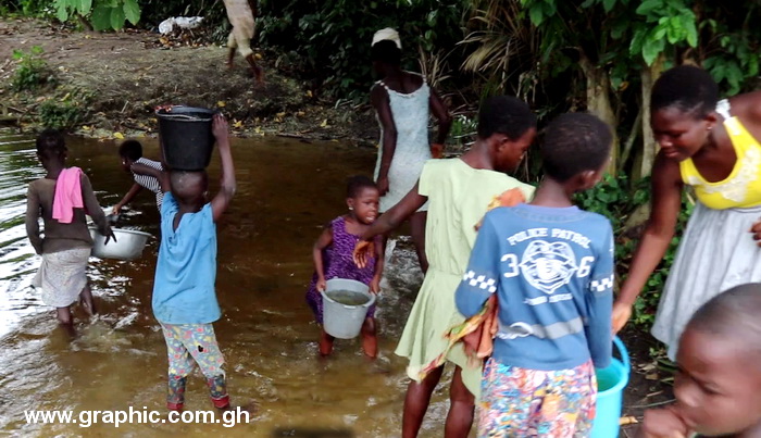 Children of Owusukrom hauling water home from the Anfam river