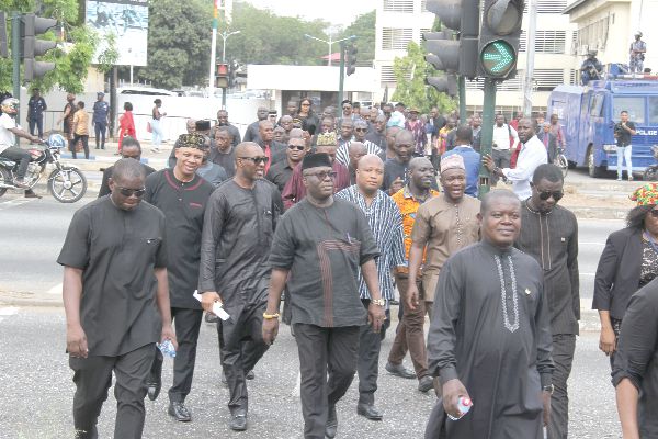 Minority MPs march to the Police Headquarters after they had walked out of the Chamber during the swearing-in of Ms Lydia Seyram Alhassan last Tuesday