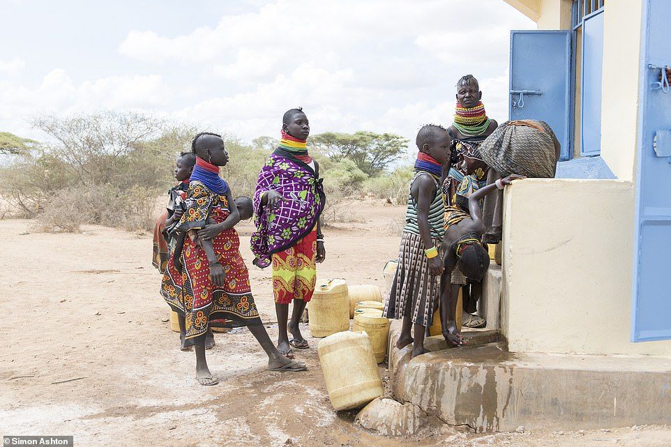Women arrive with their containers to gather clean water from the new borehole. The solar-powered technology provides water from 110 metres underground 