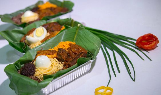 food packaged in green leaf and takeaway