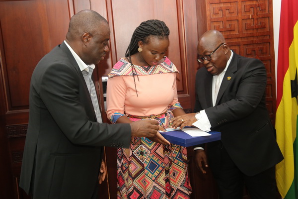 President Akufo-Addo and Dr Mohammed Ibrahim Awal (left), Minister of Business Development interacting with Miss Vanessa Limann (middle), the overall winner of the Presidential Pitch competition.
