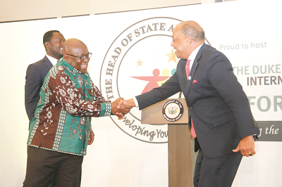 President Akufo-Addo in a handshake with Mr Paul Boateng (right), Chairman of the Awards International Council