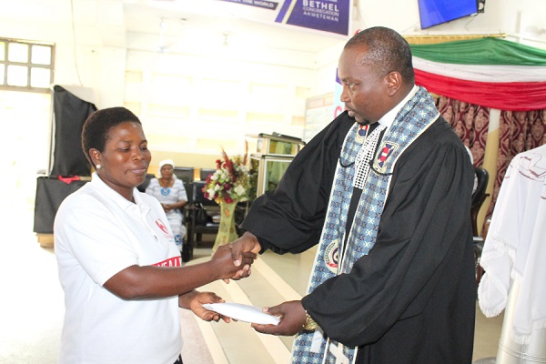 Rev Ansa presenting the cash to Mrs Wiafe Rev Ansa presenting the cash to Mrs Wiafe