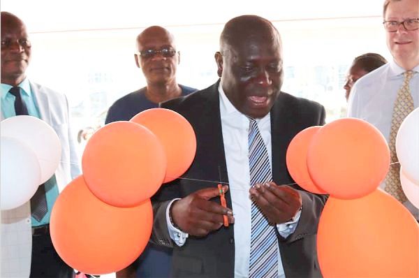 The building housing the new office. INSET: Mr Vincent Sowah Odotei, Deputy Minister of Communications cutting a tape to inaugurate the office. Picture:ESTHER ADJEI