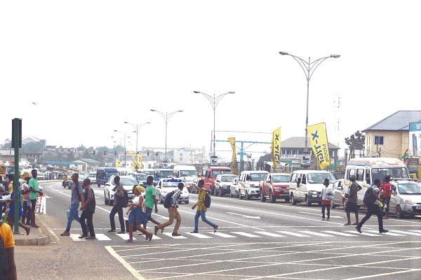 Pedestrians rushing to cross the zebra crossing at Abeka Lapaz in Accra to avoid being knocked down by vehicles.