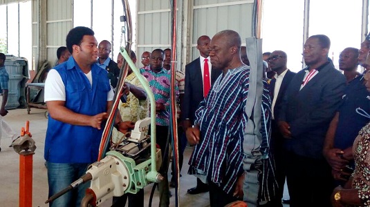 Mr Kwadwo Safo Jnr (left) taking the Vice-President through the vehicle manufacturing process