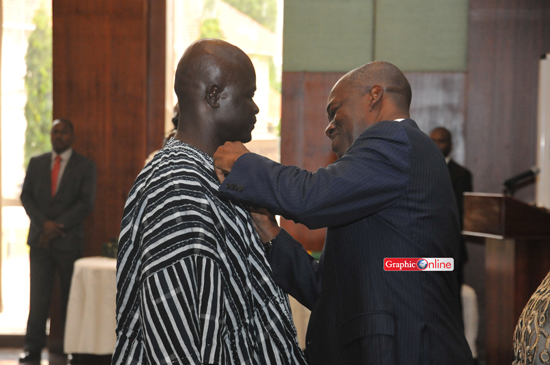 DSC 4200 Vice President Amissah Arthur decorating one of the health workers at the awards ceremony. Picture by Ebow Hanson