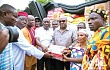Former President John Mahama presenting the items to the Appiatse Disaster Relief Committee