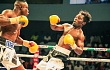 Charles Tetteh of Panix Gym (left) launches an attack on Michael Tagoe of Seconds Out Gym in their featherweight clash
