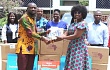 Juliet Yaa Asantewaa Asante (right), Founder of the Yaa Asantewaa  Foundation, presenting some item to Hayford Siaw (left), Chief Executive Officer of the Ghana Library Authority. Picture: ESTHER ADJORKOR ADJEI