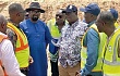 Kwabena Bempong (2nd from left); Resident Chief Engineer, briefing Kwasi Amoako-Attah (3rd from right), Minister of Roads and Highways and his entourage