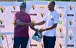 Dr Ofosu Asare (left) presenting a shirt to the technical director of the Ghana Cycling Association (GCA), Mr Shaaban Mohammed