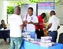  An insurance agent (right) explianing a policy to a participant at the fair