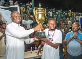 Mustapha Ussif, the Minister of Youth and Sports, presenting the trophy to the skipper of Kasoa