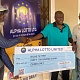 Sellas Tetteh recieving the dummy cheque from some officials of Alpha Lotto
