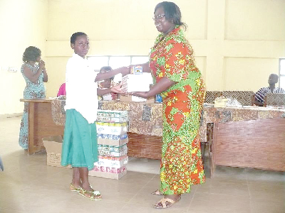 • Fatima Alhassan (left), a primary six pupil of the Bole Jugbor Primary School, receiving her award from the Regional Programme Manager of ActionAid, Madam Esther Boateng.