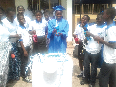 aSome students popping soft drinks to mark the anniversary. 
