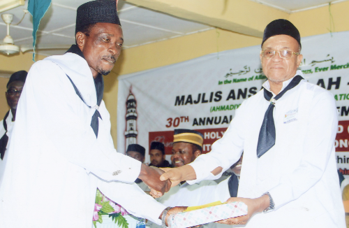 Mr Mahmud Khalid (right), former Regional Minister for the Upper West, presenting a prize to a member of the Ahmadiyya Muslim Elders Association.